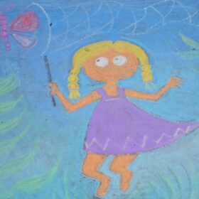 A girl closes her net in on a butterfly in this child’s chalk art work. Photo by Pete Zamplas.