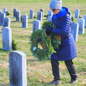 Joseph McDowell Chapter DAR member Nancy Whitman places a fresh wreath at a headstone at the Western Carolina State Veterans Cemetery in Black Mountain. Photo courtesy of Robert Coffey.
