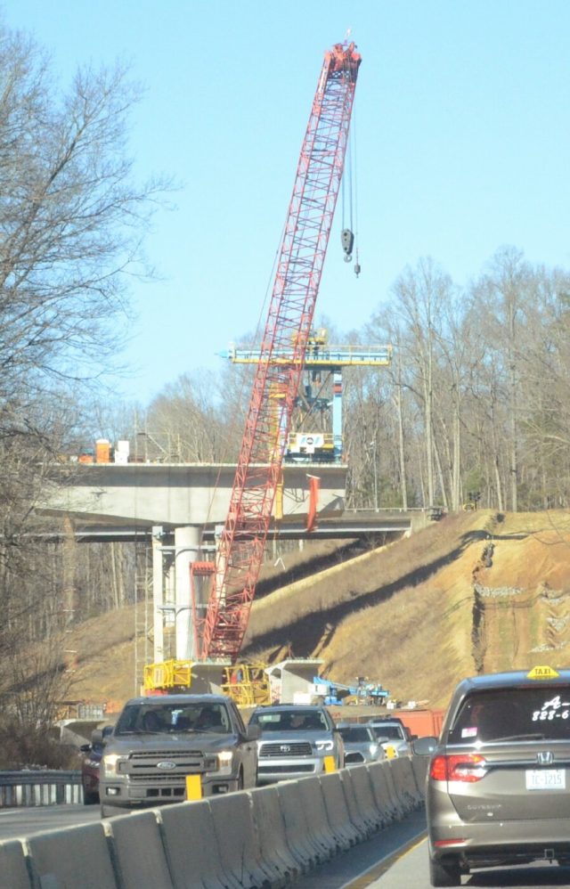 This bridge near exit 37 is in its early phase of construction, on its east side. It sports a red crane and a blue lift tower. Photo by Pete Zamplas.